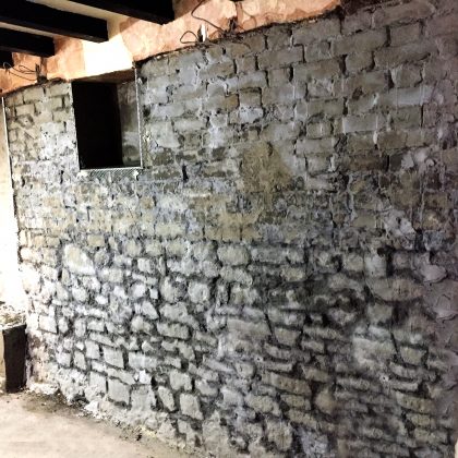 Original plaster and render courses removed before damp proofing begins