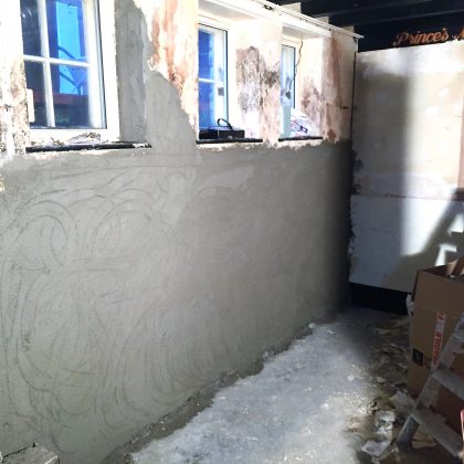 Course of render applied to damp proofed wall Bristol